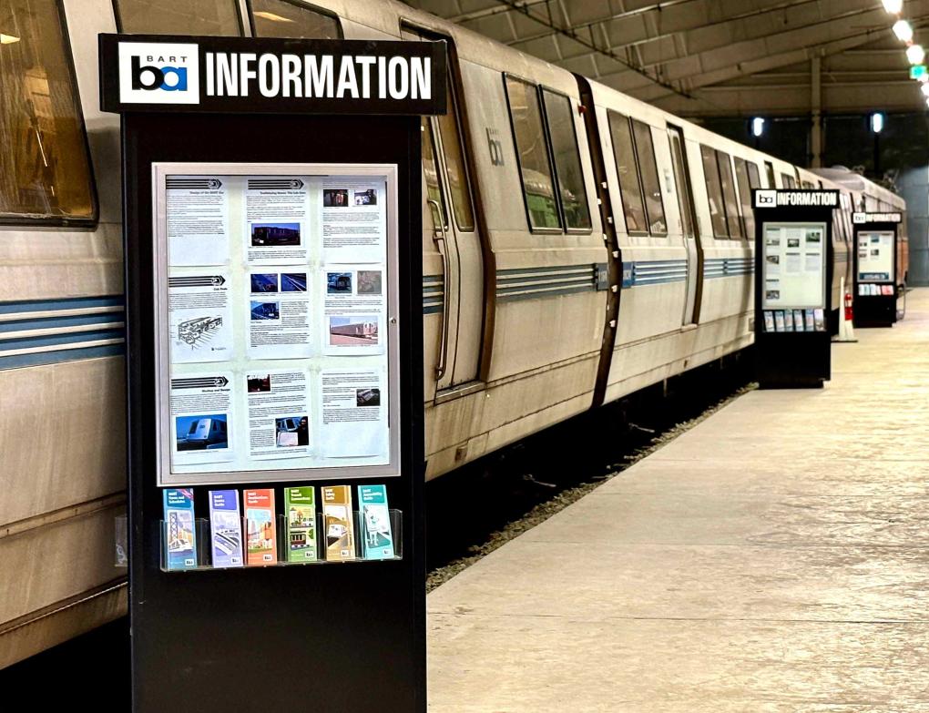 BART information sign in front of a BART legacy car