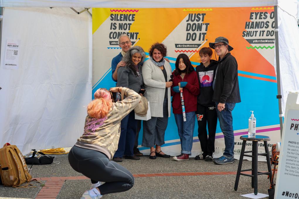 Participant pose for a photo at Not One More Girl's Art Activation event at West Oakland BART Station on April April 24. 