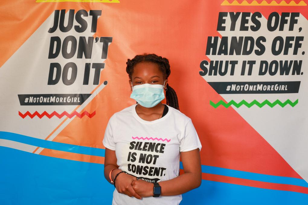 A young girl poses for a photo at Not One More Girl's in-person event at Akoma Market in Oakland on April 18. Photo: Stephen Woo
