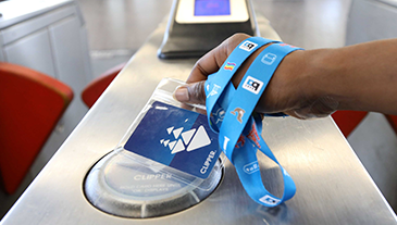 Someone tagging a clipper card at a fare gate